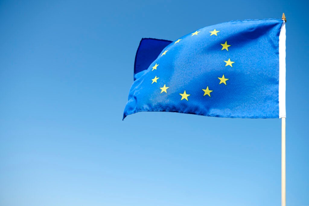 waving european union flag blue background