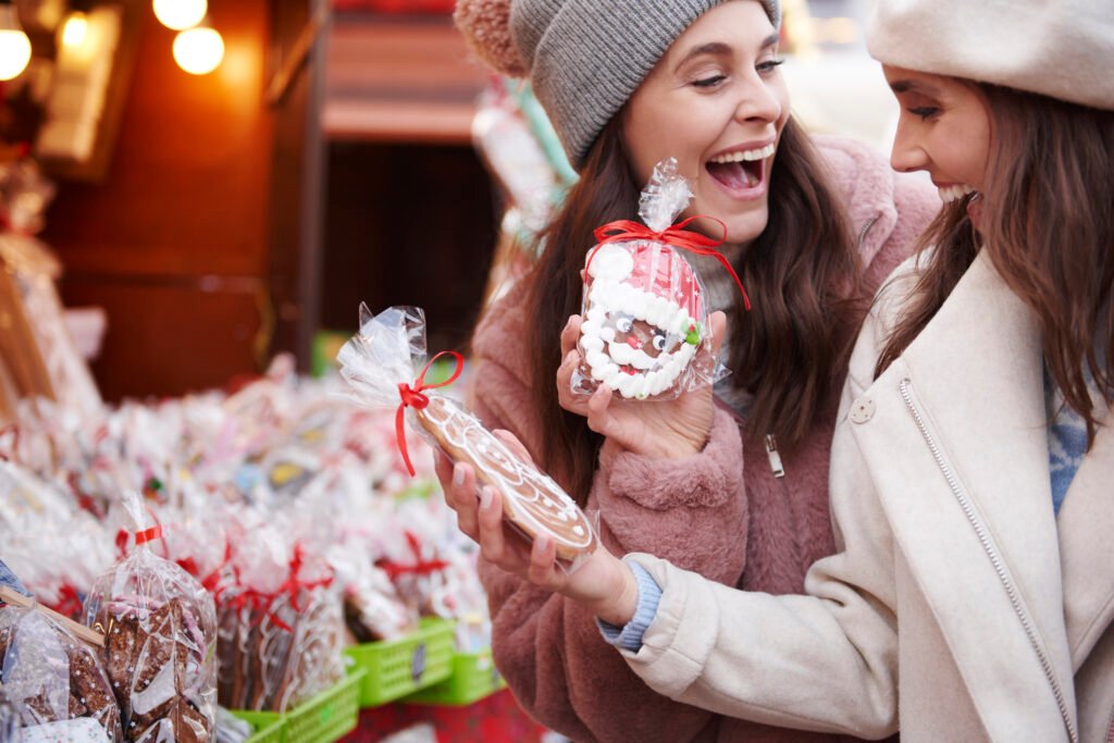 two women buying ginger breads christmas market
