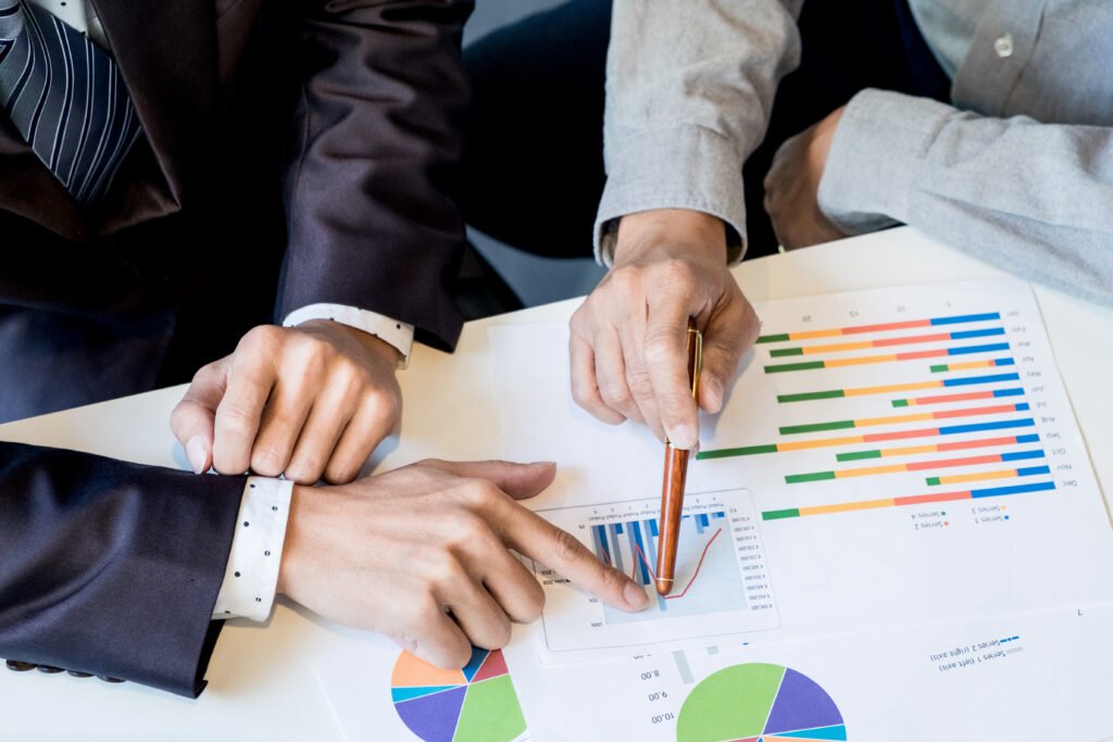 team work process young business managers crew working with new startup project labtop wood table typing keyboard texting message analyze graph plans