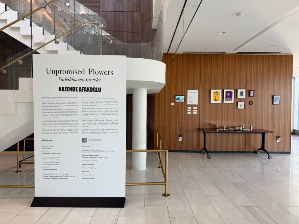 Entrance panel of the Unpromised Flowers exhibition at Turkish House, New York, with framed artworks on a wooden wall behind